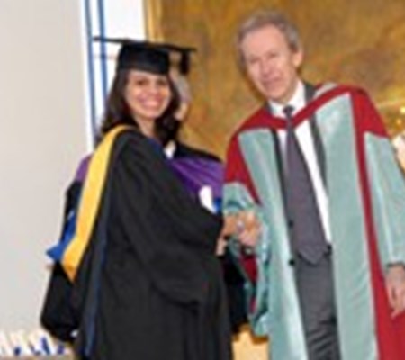 A student receiving award from the scholar Dr. Farhad Daftary
